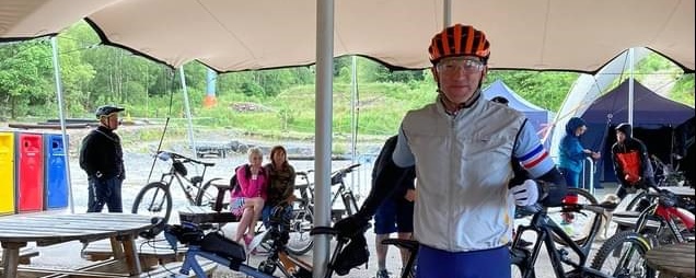 Bikeability volunteer Neil standing next to his bike