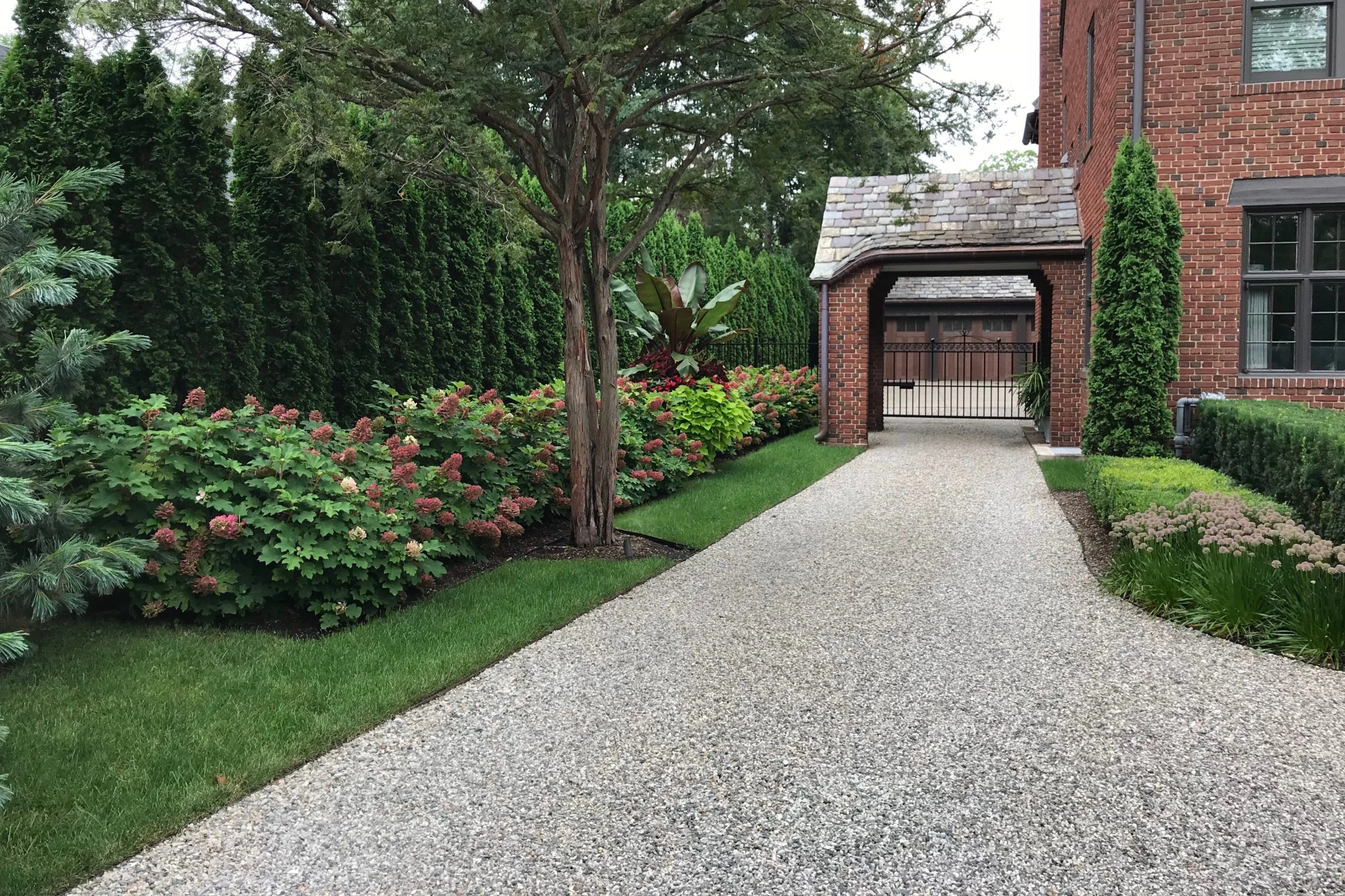 A crushed stone driveway featuring natural textures and earthy tones, adding rustic charm to the landscape.