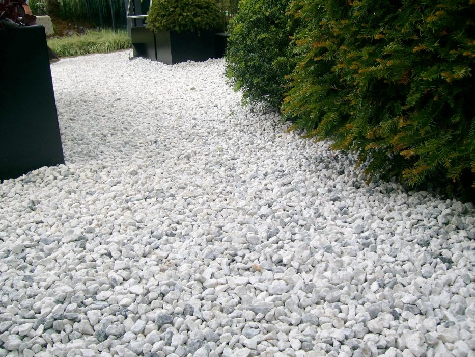 A white marble chips driveway, showcasing a clean and elegant surface that enhances the modern aesthetic of the home.