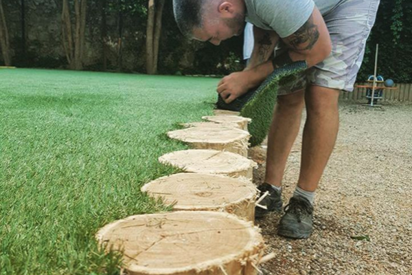 an image of a man leveling soil before applying turf to the floor