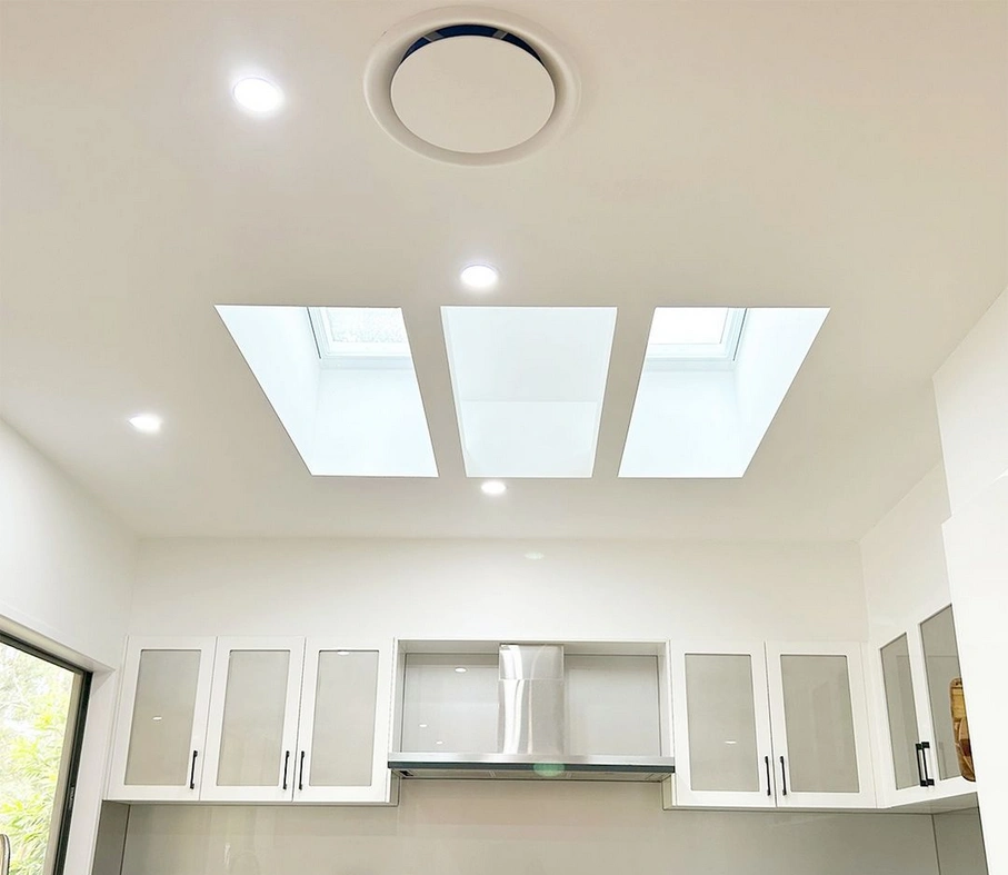 Roof windows installed within a kitchen to create a skylight for the space, letting in more natural light. 