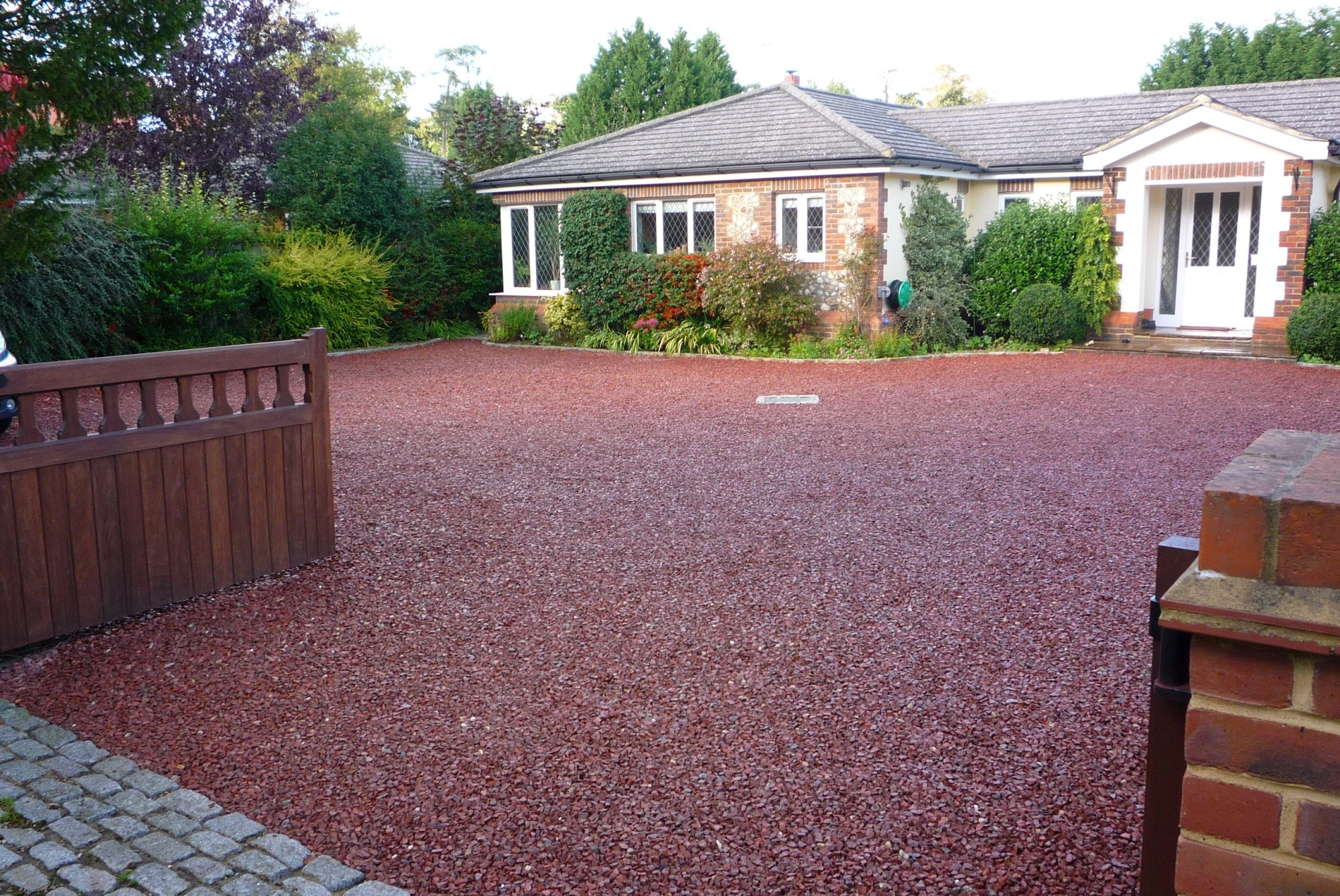 A colorful gravel driveway, featuring vibrant hues and diverse textures, adding personality and charm to the outdoor space.
