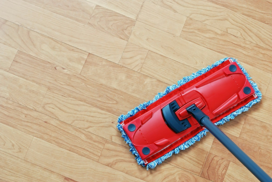 an image of a bright red mop being used to clean a laminate floor