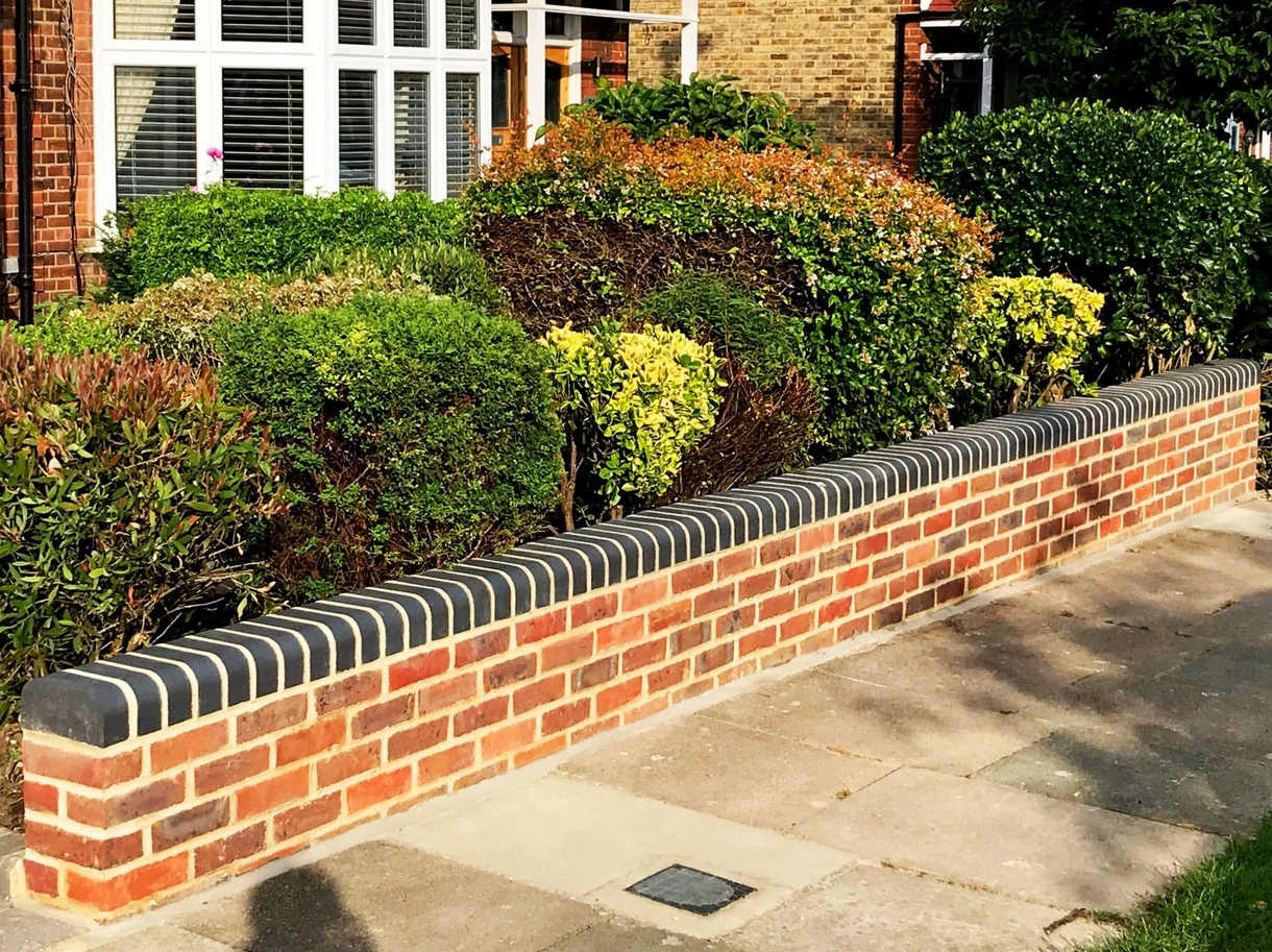 A low brick wall topped with railings is a great option, and is also great for security. 