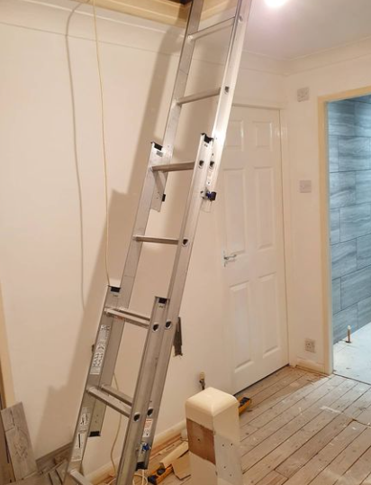 an image of a chrome ladder being used to reach loft