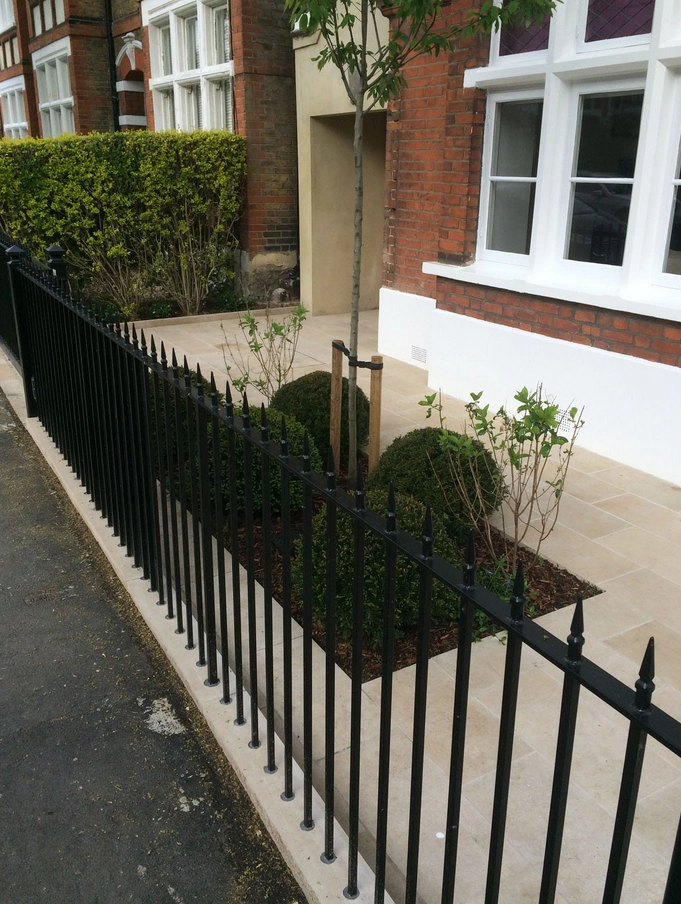 Wrought iron fences at the front of the garden offer both durability and style.