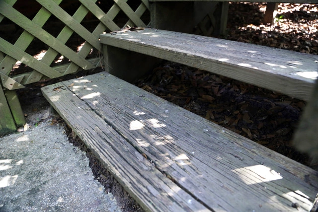 An old deck, showing signs of decay and aging, which could also do with some treatment and maintenance. 