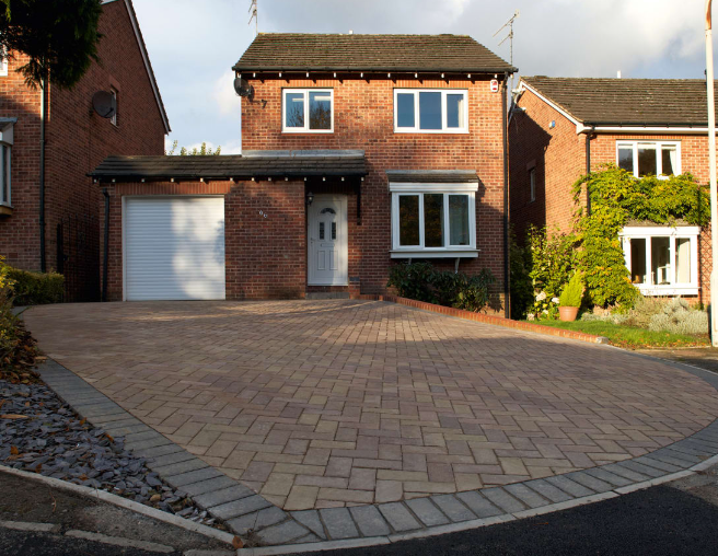 an image of a modern home with clean looking block paving driveway 