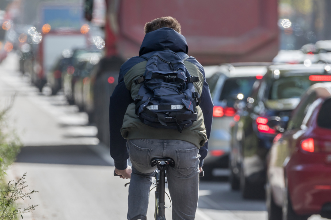 person on bike riding away 