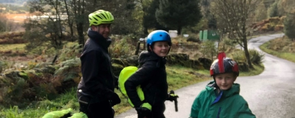 Bikeability volunteer Jamie and his family on bikes in a rural area