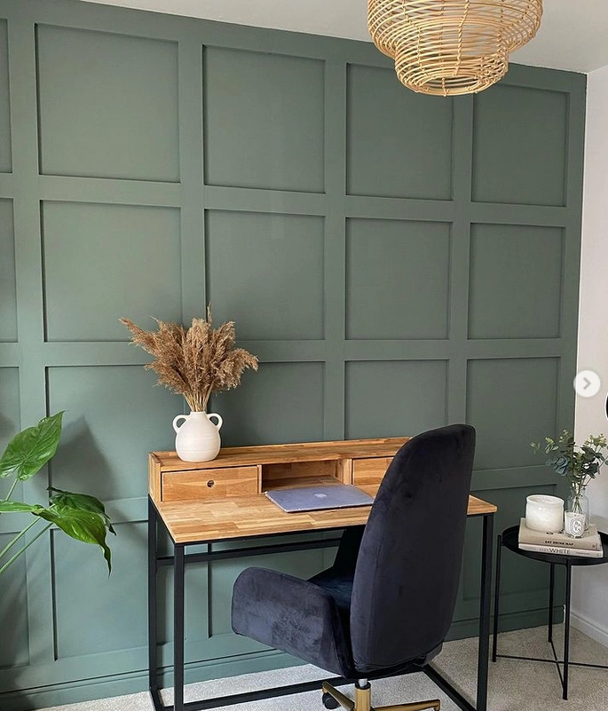 Sage green wall panelling used on a statement wall for a focal piece within a home-office.