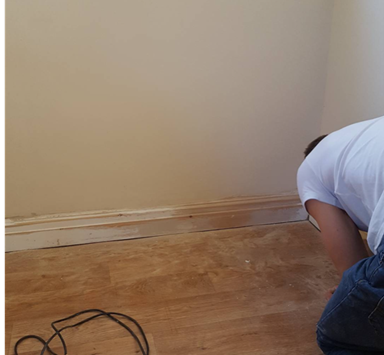 an image of a man priming his skirting boards