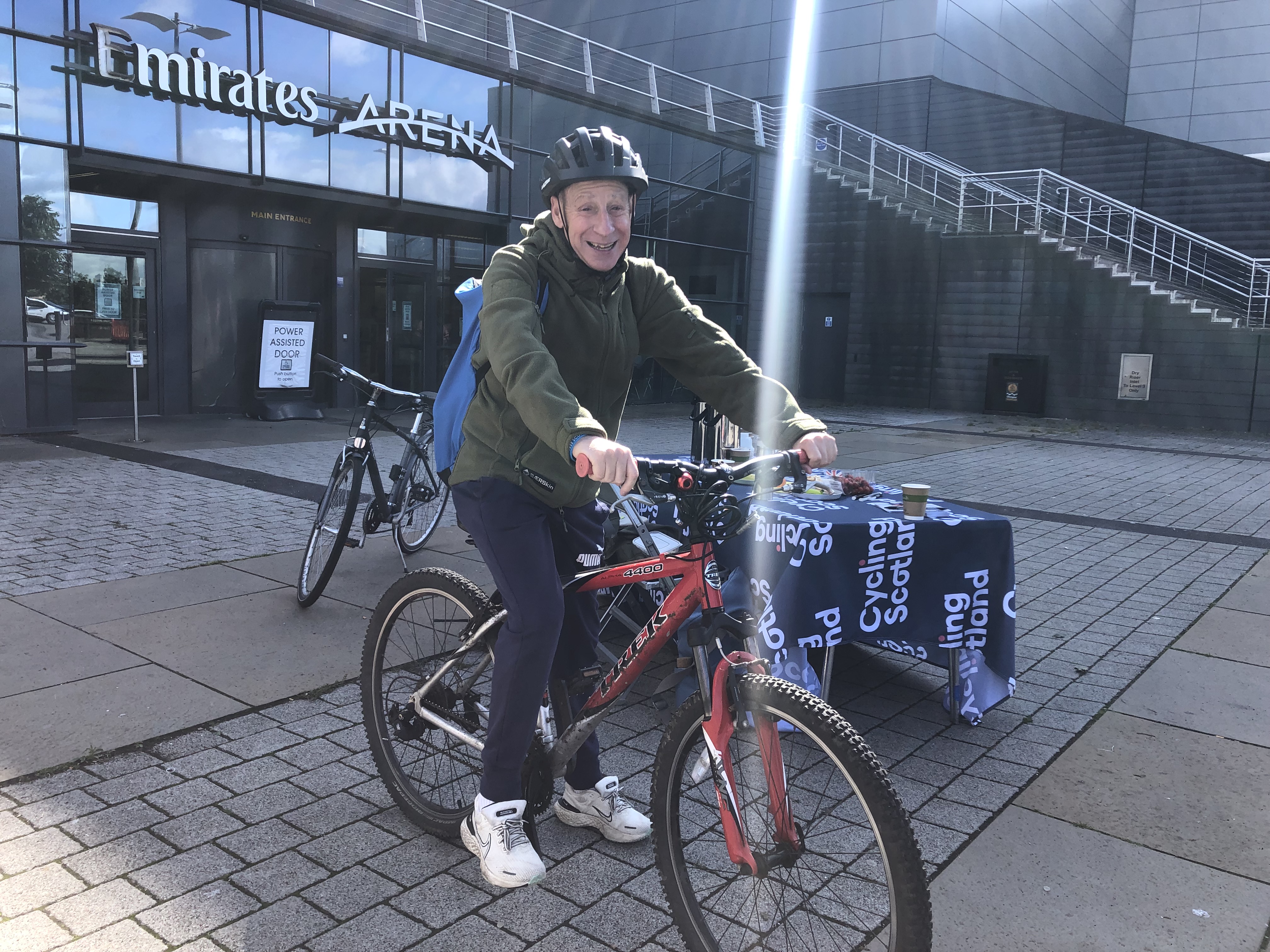 man on a bike outside the Glasgow Sport venue