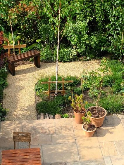 Elegant gravel driveway winding through the garden, blending natural textures with functional beauty for a picturesque landscape. 