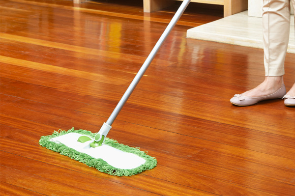 an image of a woman using mop against bright red laminate floor
