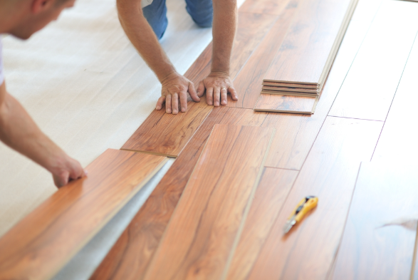 an image of men fitting laminate flooring together to be fitted