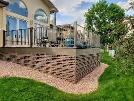 A completed deck attached to the outside of a house. 