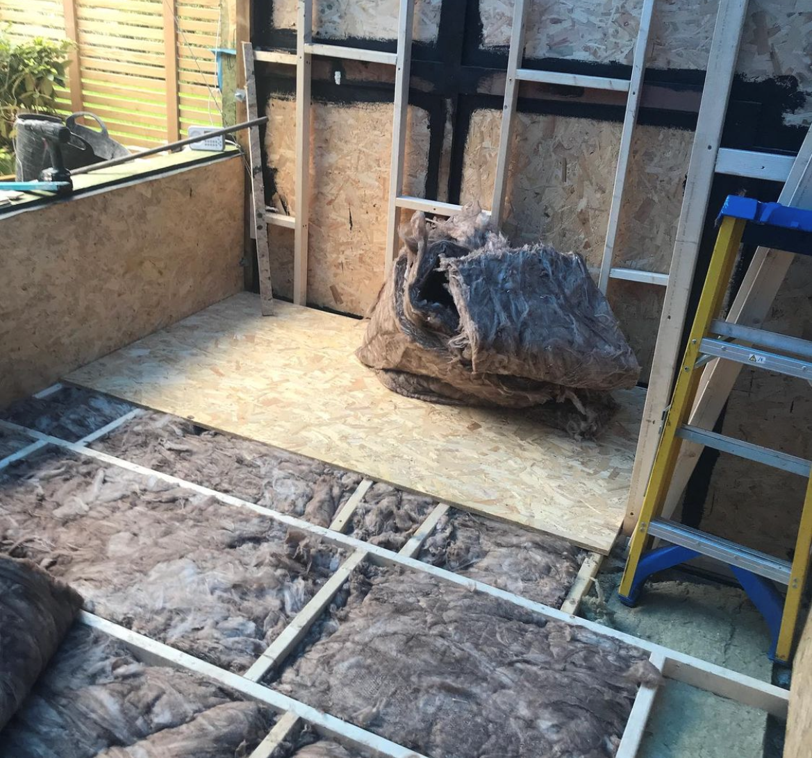 an image of blanket insulation alongside the construction of a shed