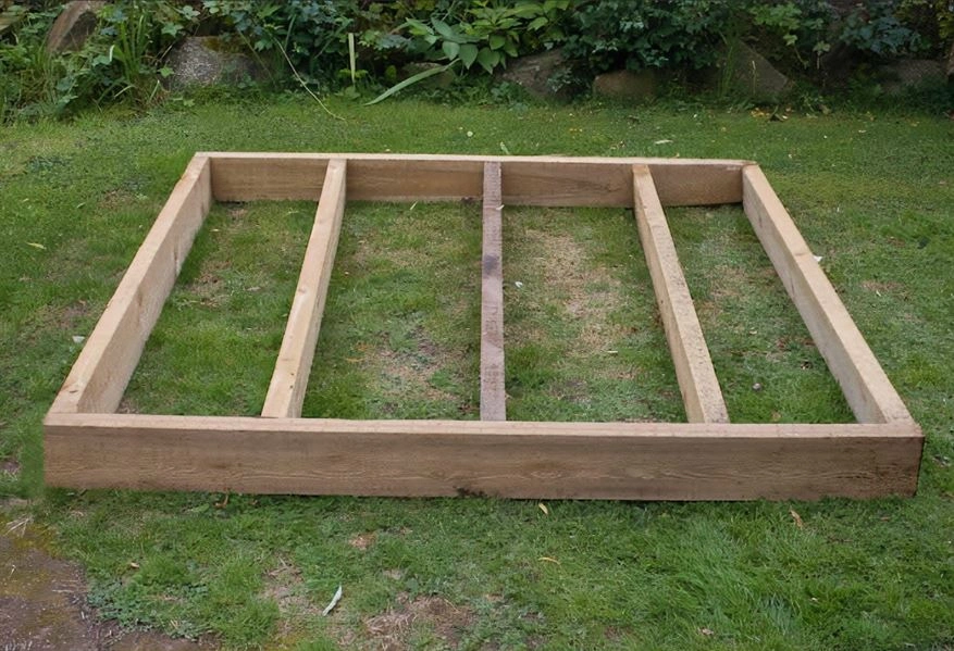 A shed base constructed on the grass. A shed base is used as a foundation for an outside building to stabalise the structure. 