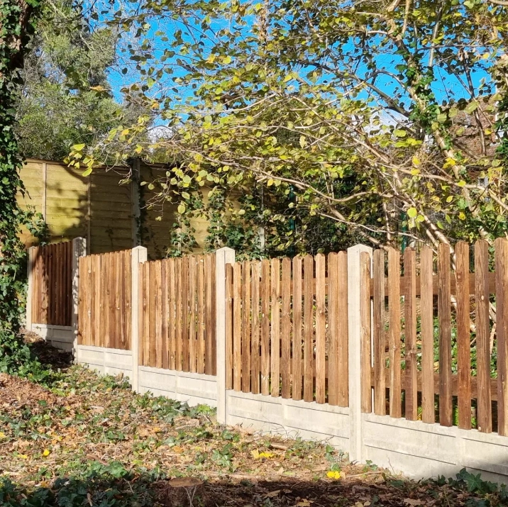 an image of a dark brown picket fence, with concrete posts and trim. 