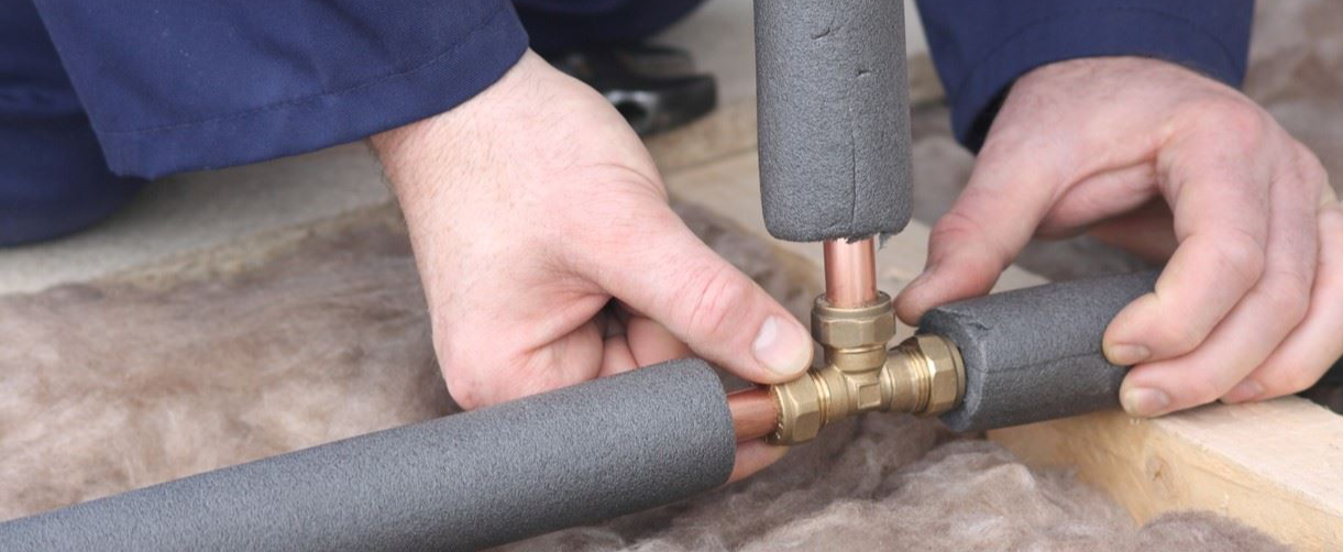 an image of a person checking their pipes within the home
