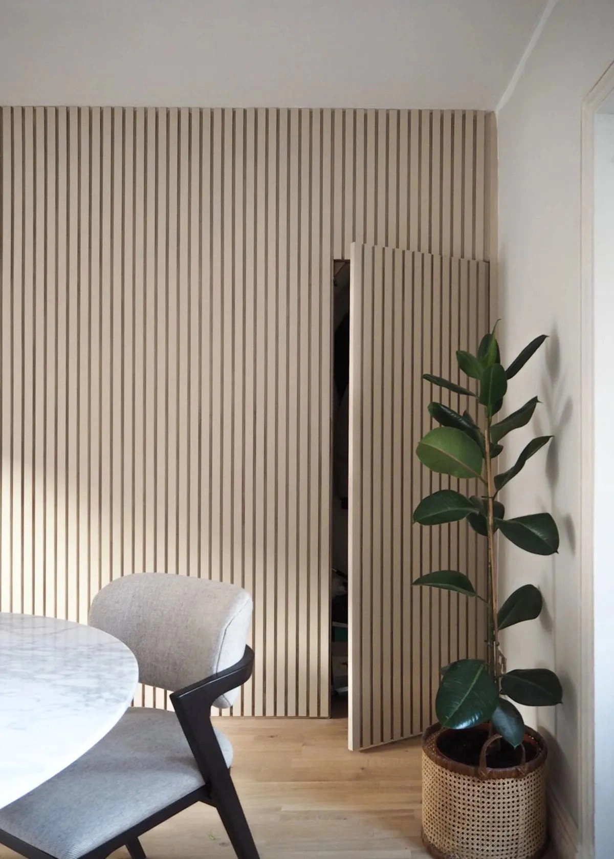 Slatted wall panelling being used to conceal a hidden door, which can be used as a storage cupboard or as an en suite.