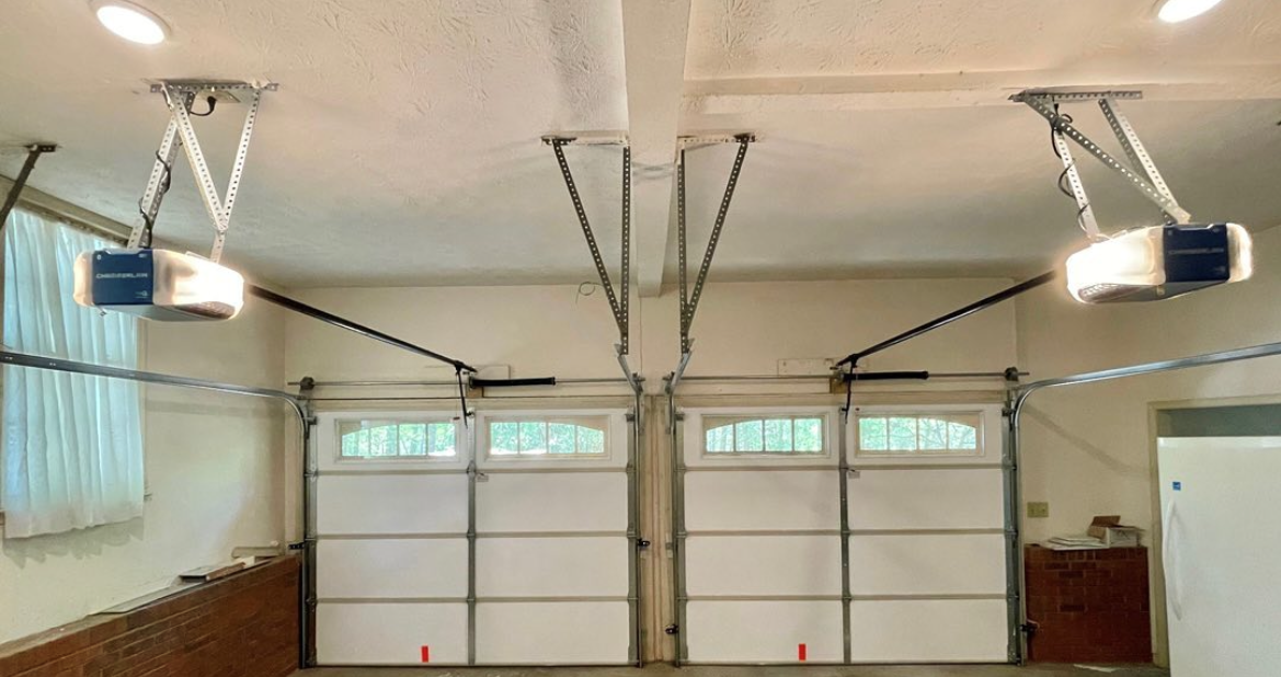 An image showing inside a empty double garage with double garage doors. 