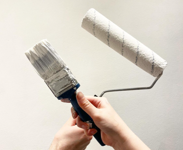 an image of a white paint brush and paint roller
