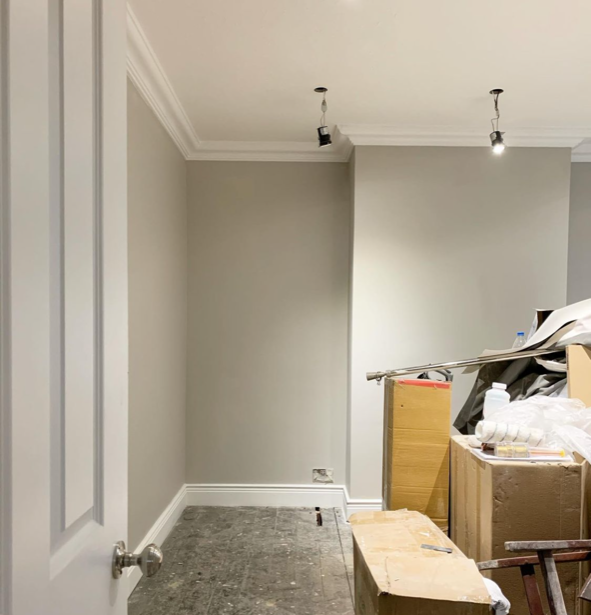 an image of a white painted wall with light fittings and skirting boards
